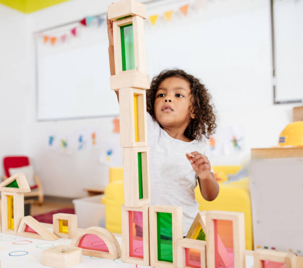 istock Toddler building new tower with wooden blocks 887557794