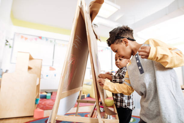 istock Kids are drawing with chalk in kinderagrten 887557830