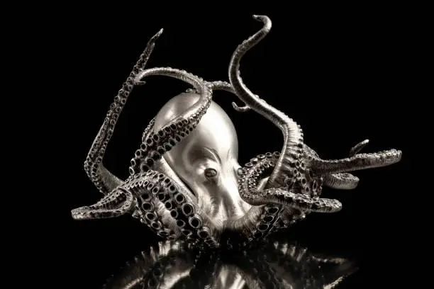 A octopus made of silver, isolated on black background.