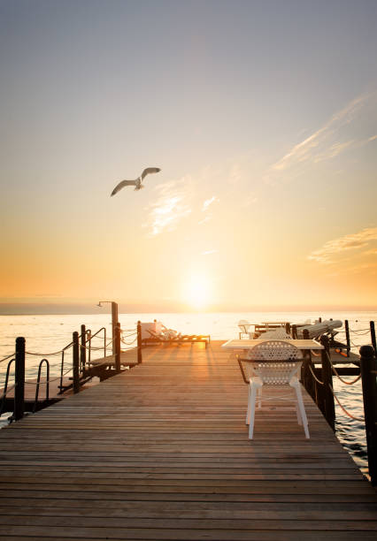 Wooden pier stretching into the sea cloudy sunset