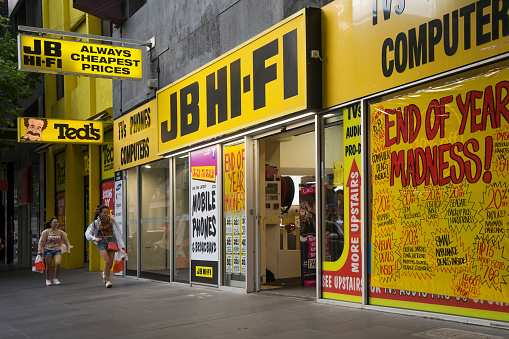 Melbourne, Australia - December 26, 2016: Two women run towards the JB Hi-Fi store on Elizabeth Street in the city. The electronics retailer had just opened for Boxing Day sales.