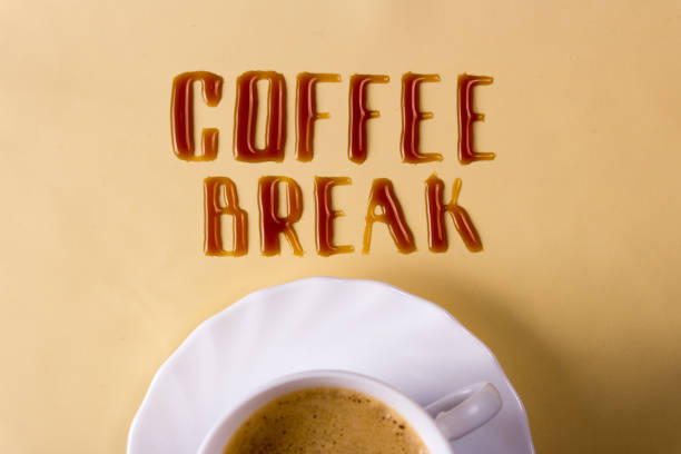 istock Coffee break. Letters of spilled coffee and a cup 887559118
