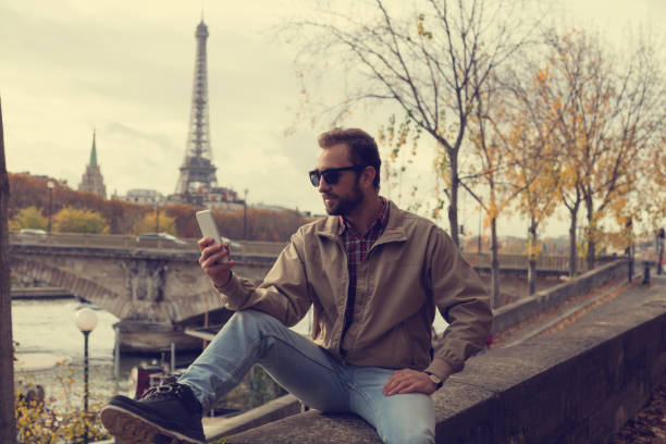 istock Modern guy using cellphone in the European city. 887563856