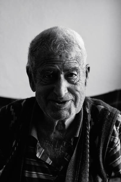 old man looking at camera and talking about his memories - portrait black and white senior men wisdom imagens e fotografias de stock