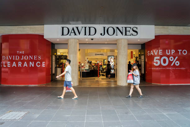 Melbourne, Australia - December 26, 2016: A man and woman walk past the David Jones store at Bourke Street Mall. The department store was open for Boxing Day sales.