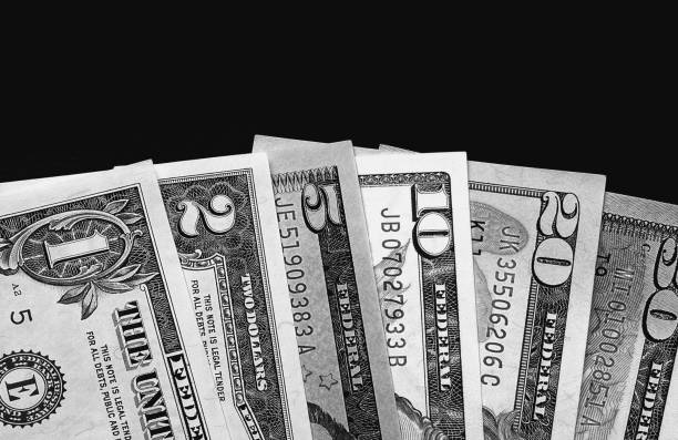 istock Us dollars on black board background black and white. 887568926