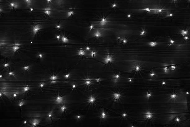 istock Christmas lights black and white effect background. 887571546