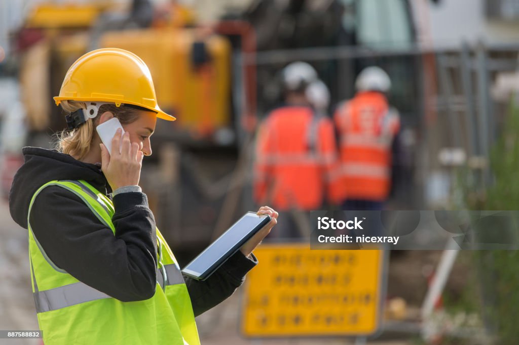 female ingineer working on constuction site female construction woman using electronics on construction site Construction Site Stock Photo