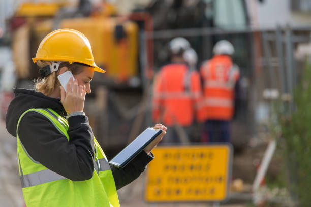 female ingineer working on constuction site female construction woman using electronics on construction site electronic clipboard pictures stock pictures, royalty-free photos & images