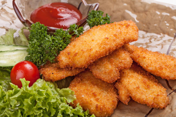 istock Pieces of chicken fried in batter garnished with vegetables. 887602594