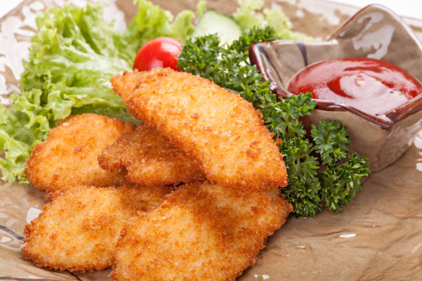 istock Pieces of chicken fried in batter garnished with vegetables. 887602696