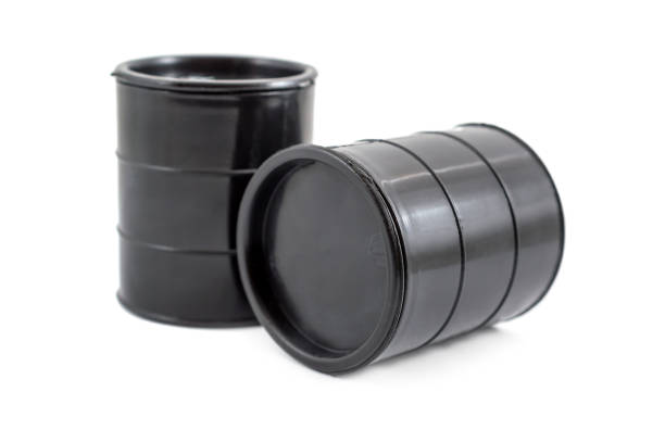 istock Two decorative black fuel oil barrel on white. 887612972