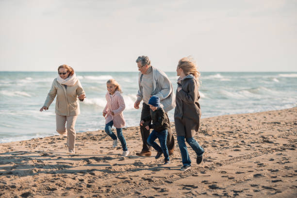 istock family spending time on seashore 887613194