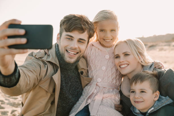 istock family taking selfie on smartphone 887613528