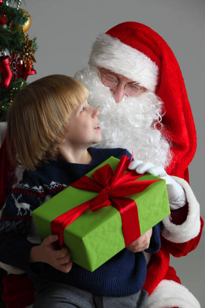 istock Boy on santa claus knees 887613906