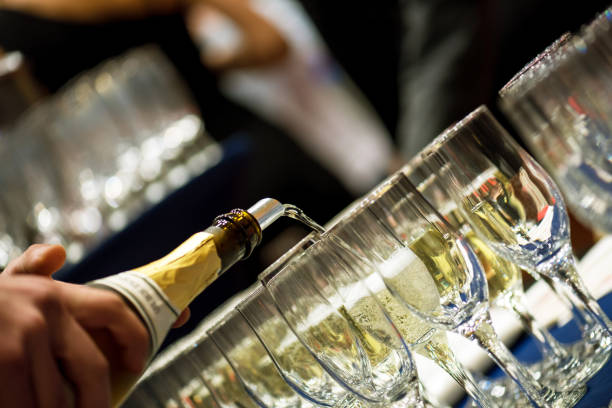 istock Bartender pouring champagne into glass. 887623544