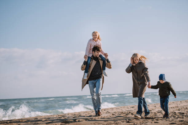 istock parents and kids on seashore 887635674