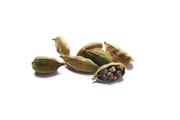green dry seeds of cardamom isolated on white background