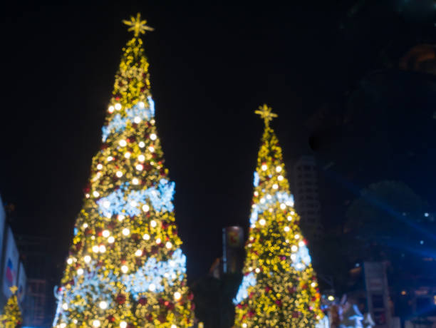 istock blur image of artificial pine christmas tree , bokeh of LED decorative light defocused background and textured,  for Christmas Eve , New Year party holiday and celebration background 887646582