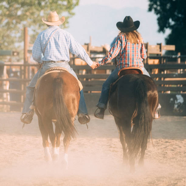 istock Cowboy Couple Holding Hands 887646808
