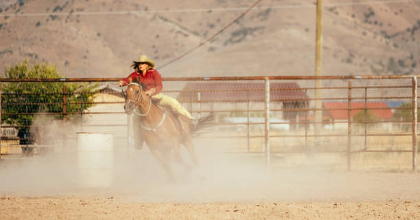 istock Barrel Racing Cowgirls in a Rodeo 887646996