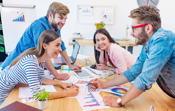 istock Cheerful and confident young team of architects. Start up concept 887647662