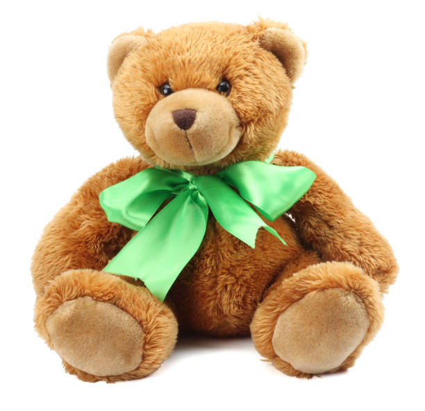 a green bear doll sitting on white background isolated