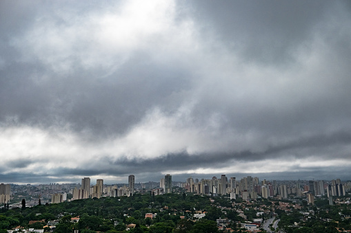 Rain weather  theme. quick moving rain cloud over forest