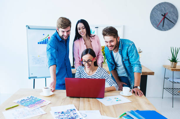 istock Group of young business people working and communicating together while sitting at their working places in office 887651342