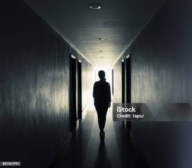 Women Are Walking Alone In The Darklight At The End Of The Tunnel Concept Stock Photo - Download Image Now