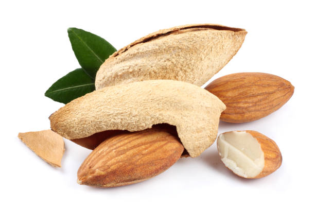 istock almond with green leaf isolated on white background 887652080