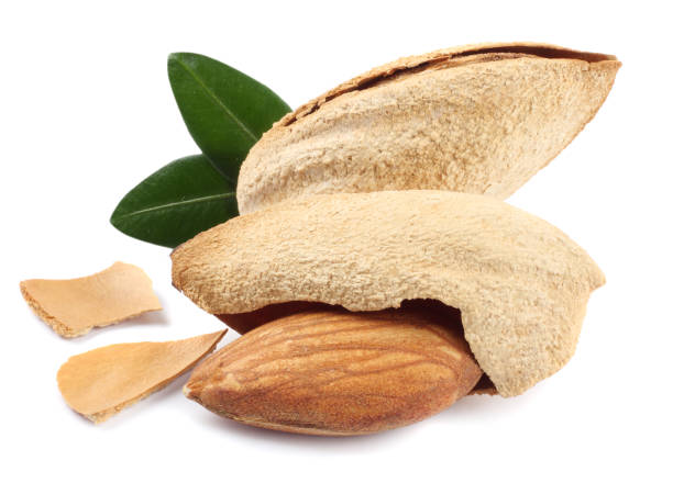 istock almond with green leaf isolated on white background 887652098
