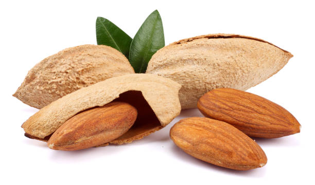 istock almond with green leaf isolated on white background 887654262