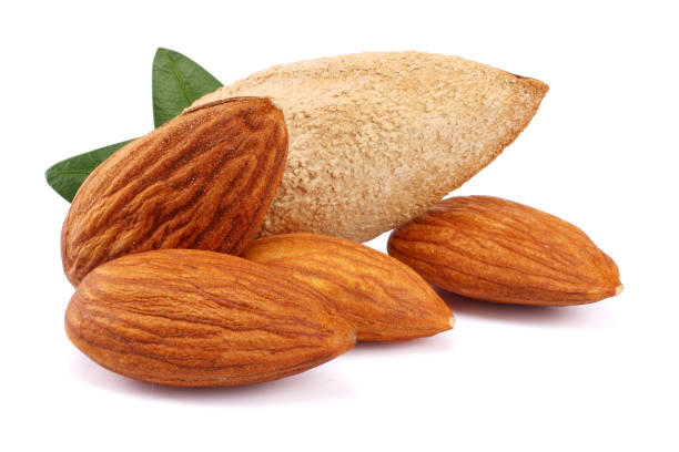 istock almond with green leaf isolated on white background 887654268