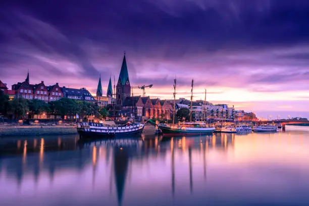 Morning Skyline of Bremen Old Town as seen over Weser river. Long exposure, artistic filters applied