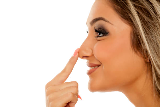 istock Profile of young woman touching her nose on white background 887664876