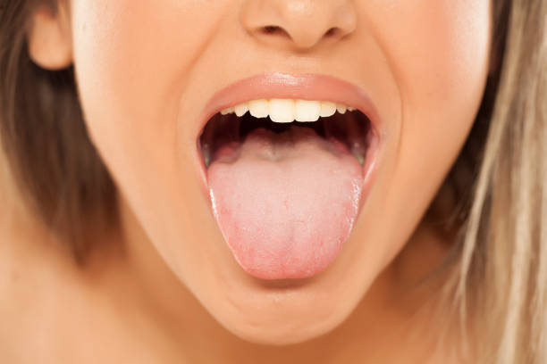 istock woman shows her tongue 887664898