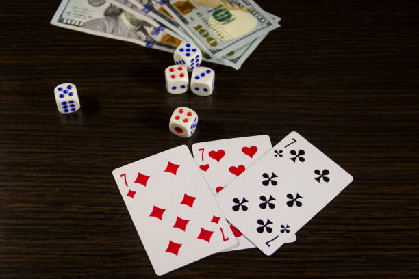 istock Playing cards, dice and dollars on a table 887665006