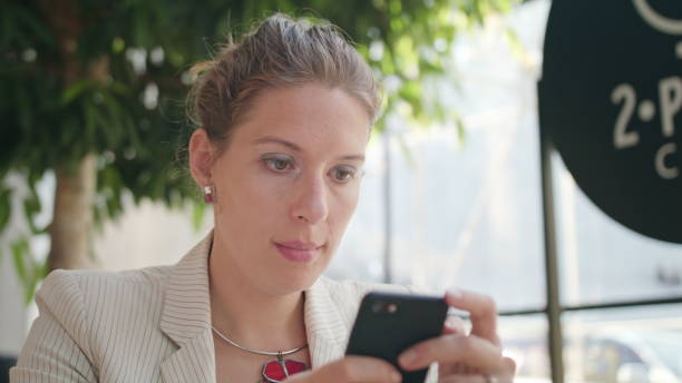 istock A Young Lady Using a Smartphone in the Cafe 887667396