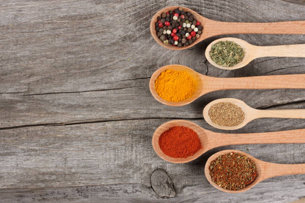 istock Herbs and spices in spoons on old wood background 887670088