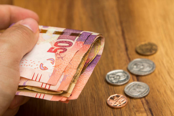 istock A hand holding South African money 887680326