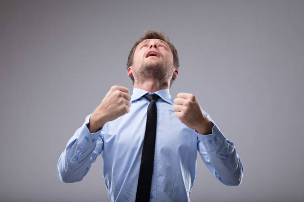 istock Young businessman cheering in exultation 887680486