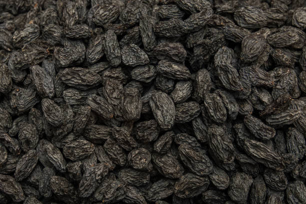 istock Background of lined dark raisins. 887680774