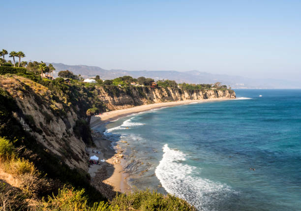 Paradise Cove Malibu, Zuma Beach, emerald and blue water in a quite paradise beach surrounded by cliffs. Malibu, Los Angeles, LA, California, CA, USA stock photo