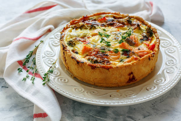 istock Quiche with salmon, broccoli,red pepper and thyme. 887681182