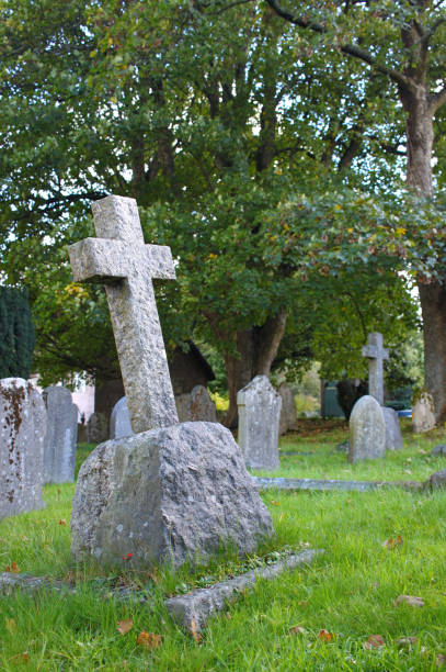 istock Stone cross on a tombstone 887690566