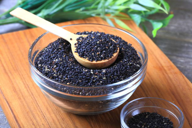 black sesame seeds - sesame seed spoon scoop imagens e fotografias de stock