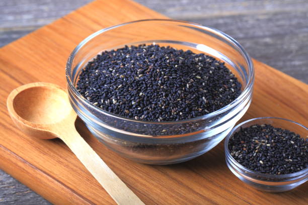 black sesame seeds - sesame seed spoon scoop imagens e fotografias de stock