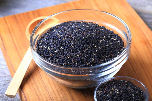 black sesame seeds - sesame seed spoon scoop imagens e fotografias de stock
