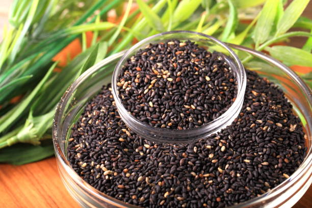 black sesame seeds - sesame seed spoon scoop imagens e fotografias de stock